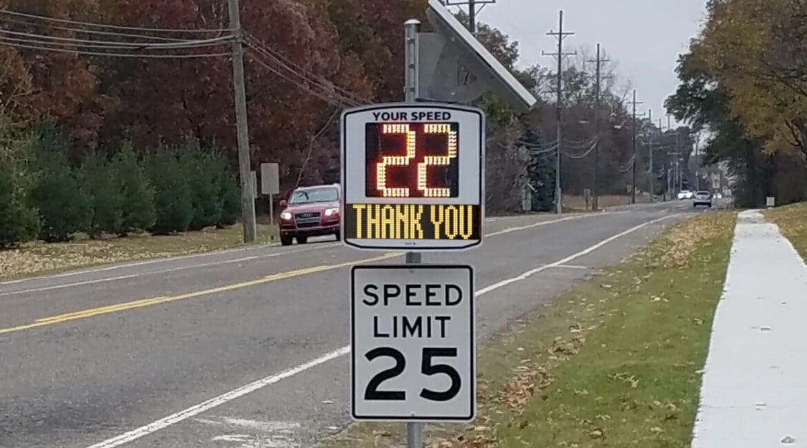 An EVOLIS Vision speed radar displaying a speed of 22 mph, on the side of a road