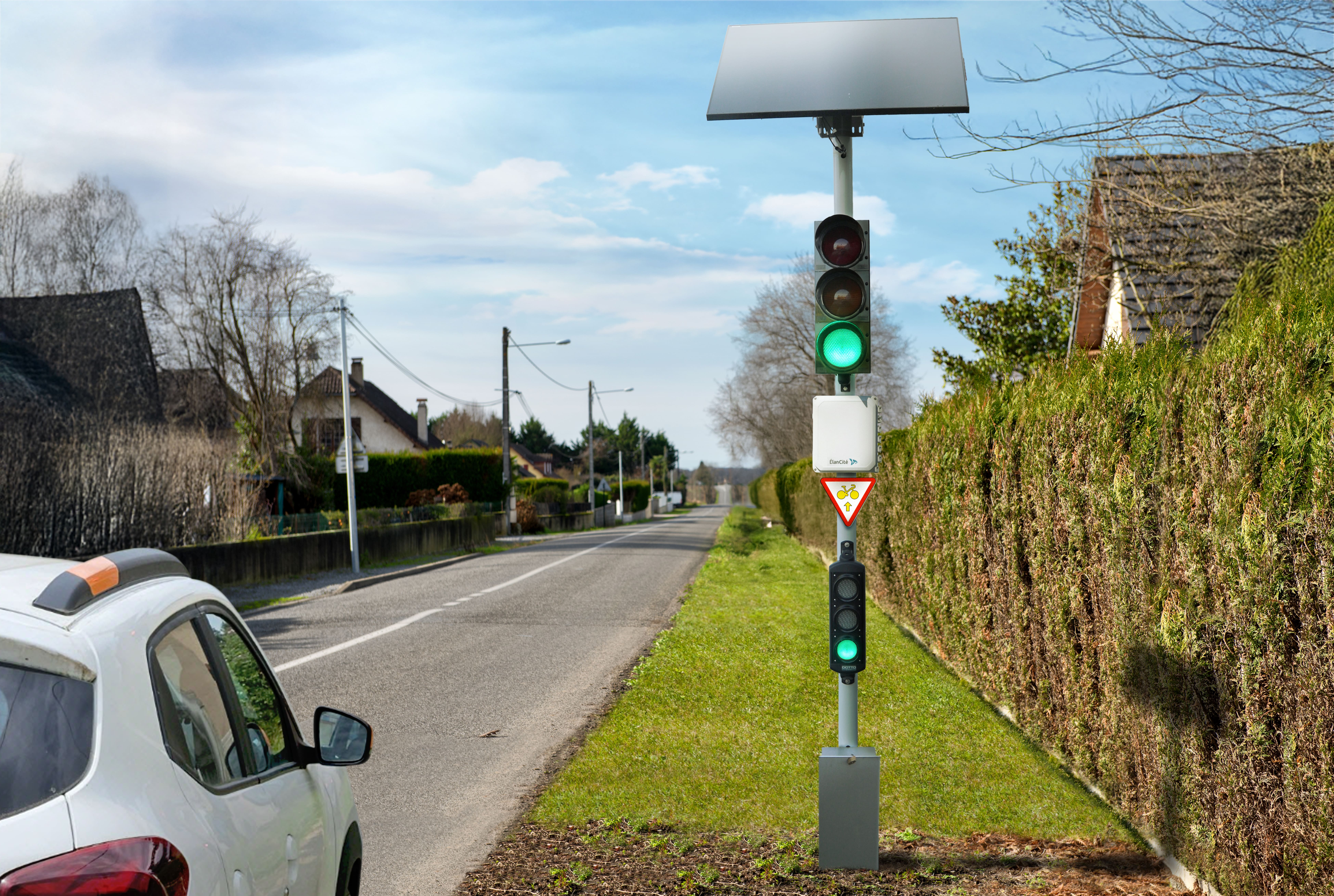 Photomontage d'un feu récompense solaire installé aux abords d'une rue pavillonnaire et qui émet une lumière vert